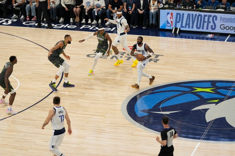 MINNEAPOLIS, MN - MAY 30: Kyrie Irving #11 of the Dallas Mavericks looks to pass the ball during the game against the Minnesota Timberwolves during Game 5 of the Western Conference Finals of the 2024 NBA Playoffs on May 30, 2024 at Target Center in Minneapolis, Minnesota. NOTE TO USER: User expressly acknowledges and agrees that, by downloading and or using this Photograph, user is consenting to the terms and conditions of the Getty Images License Agreement. Mandatory Copyright Notice: Copyright 2024 NBAE (Photo by Jordan Johnson/NBAE via Getty Images)