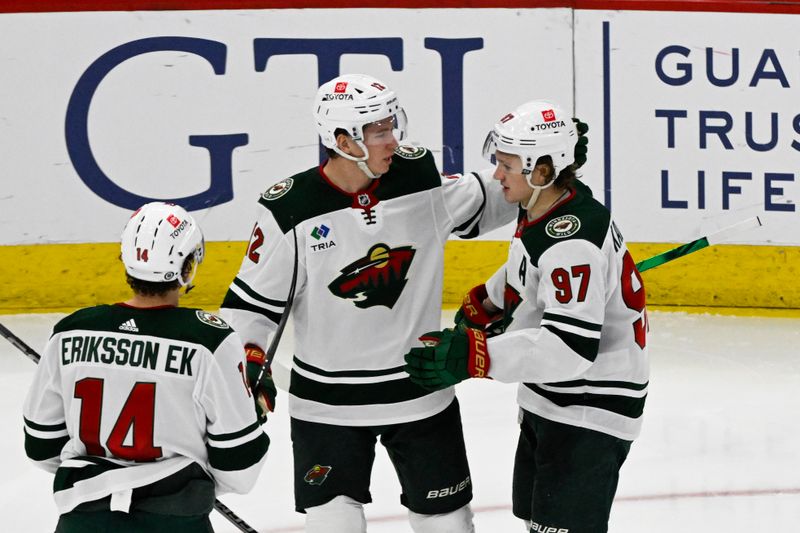 Apr 7, 2024; Chicago, Illinois, USA;  Minnesota Wild left wing Kirill Kaprizov (97) celebrates his goal against the Chicago Blackhawks with  left wing Matt Boldy (12) and  center Joel Eriksson Ek (14) during the second period at United Center. Mandatory Credit: Matt Marton-USA TODAY Sports