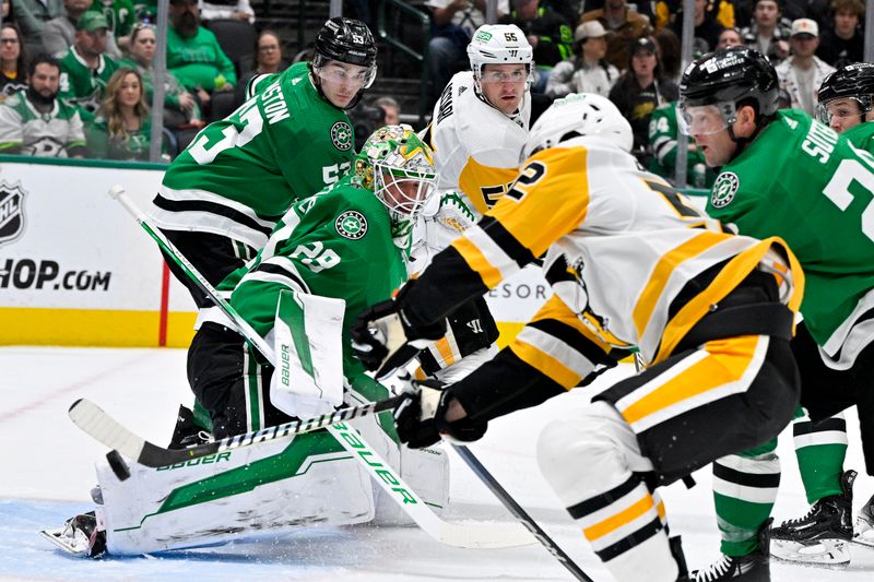 Mar 22, 2024; Dallas, Texas, USA; Dallas Stars goaltender Jake Oettinger (29) stops a shot by Pittsburgh Penguins right wing Emil Bemstrom (52) during the first period at the American Airlines Center. Mandatory Credit: Jerome Miron-USA TODAY Sports