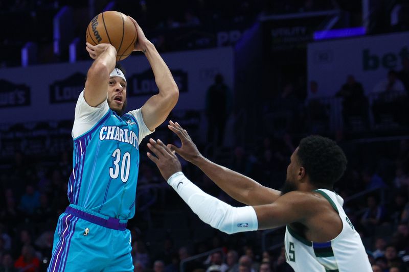 CHARLOTTE, NORTH CAROLINA - FEBRUARY 29: Seth Curry #30 of the Charlotte Hornets attempts a three point basket during the first half of the game against the Milwaukee Bucks at Spectrum Center on February 29, 2024 in Charlotte, North Carolina. NOTE TO USER: User expressly acknowledges and agrees that, by downloading and or using this photograph, User is consenting to the terms and conditions of the Getty Images License Agreement. (Photo by Jared C. Tilton/Getty Images)