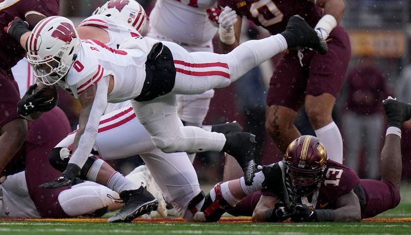 Nov 25, 2023; Minneapolis, Minnesota, USA; Wisconsin Badgers running back Braelon Allen (0) runs for a first down against the Minnesota Golden Gophers during the second quarter at Huntington Bank Stadium. Mandatory Credit: Mark Hoffman/Milwaukee Journal Sentinel via USA TODAY NETWORK