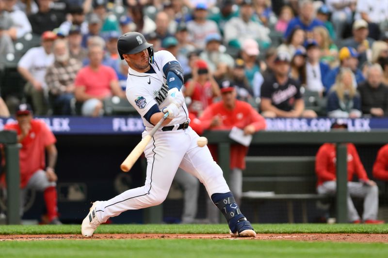 Jun 27, 2023; Seattle, Washington, USA; Seattle Mariners first baseman Ty France (23) hits a single against the Washington Nationals during the first inning at T-Mobile Park. Mandatory Credit: Steven Bisig-USA TODAY Sports