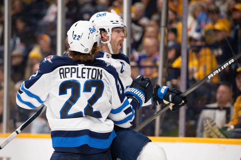 Nov 23, 2024; Nashville, Tennessee, USA;  Winnipeg Jets center Adam Lowry (17) celebrates his goal with center Mason Appleton (22) against the Nashville Predators during the second period at Bridgestone Arena. Mandatory Credit: Steve Roberts-Imagn Images