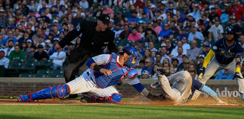 May 30, 2023; Chicago, Illinois, USA;  Tampa Bay Rays shortstop Wander Franco (5) is tagged out at home plate by Chicago Cubs catcher Yan Gomes (15) during the first inning at Wrigley Field. Mandatory Credit: Matt Marton-USA TODAY Sports