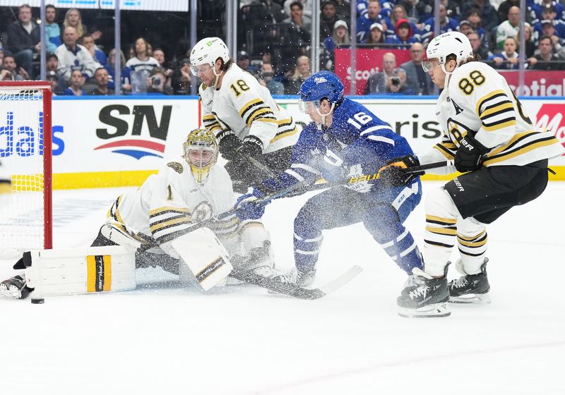 Apr 27, 2024; Toronto, Ontario, CAN; Toronto Maple Leafs right wing Mitch Marner (16) battles for the puck with Boston Bruins center Pavel Zacha (18) in front of  goaltender Jeremy Swayman (1) during the first period in game four of the first round of the 2024 Stanley Cup Playoffs at Scotiabank Arena. Mandatory Credit: Nick Turchiaro-USA TODAY Sports