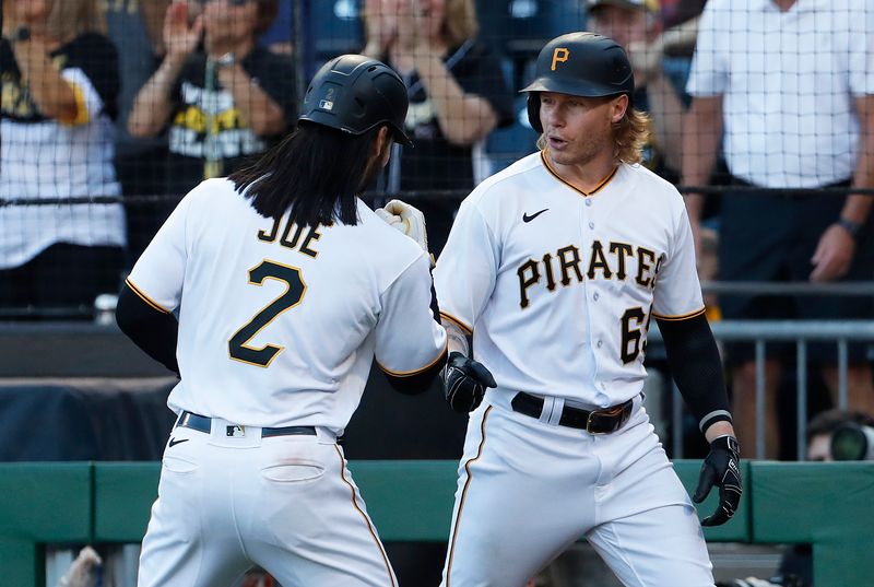 Oct 1, 2023; Pittsburgh, Pennsylvania, USA;  Pittsburgh Pirates first baseman Connor Joe (2) celebrates with left fielder Jack Suwinski (65) after Joe scored a run against the Miami Marlins during the eighth inning at PNC Park. Pittsburgh won 3-0. Mandatory Credit: Charles LeClaire-USA TODAY Sports