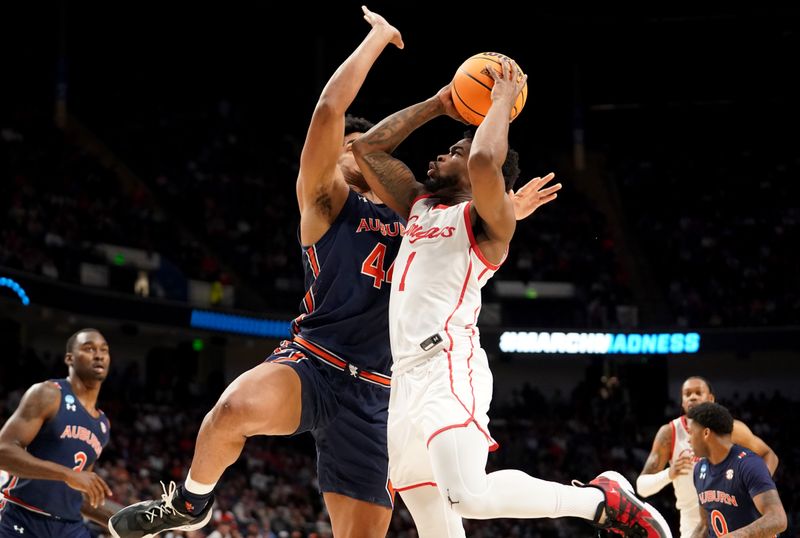 Mar 18, 2023; Birmingham, AL, USA; Houston Cougars guard Jamal Shead (1) drives against Auburn Tigers center Dylan Cardwell (44) during the second half at Legacy Arena. Mandatory Credit: Marvin Gentry-USA TODAY Sports