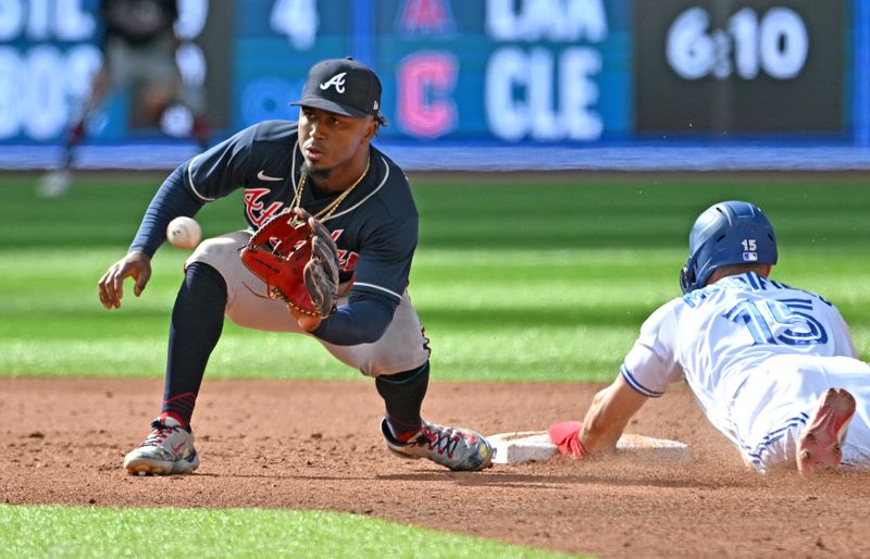 May 13, 2023; Toronto, Ontario, CAN; Atlanta Braves second baseman Ozzie Albies (1) takes the throw as Toronto Blue Jays second baseman Whit Merrifield (15) slides safely into second with a stolen base in the sixth inning at Rogers Centre. Mandatory Credit: Dan Hamilton-USA TODAY Sports