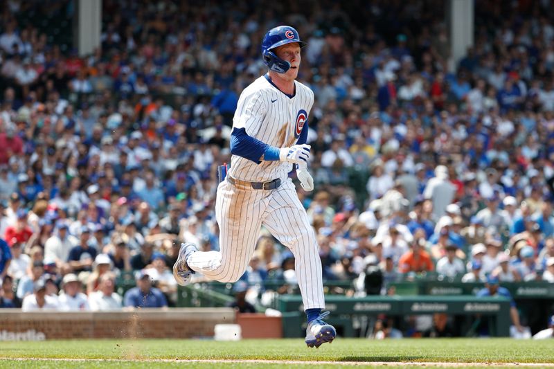 Jun 19, 2024; Chicago, Illinois, USA; Chicago Cubs outfielder Pete Crow-Armstrong (52) runs to first base after hitting an RBI-sacrifice bunt against the San Francisco Giants during the fourth inning at Wrigley Field. Mandatory Credit: Kamil Krzaczynski-USA TODAY Sports