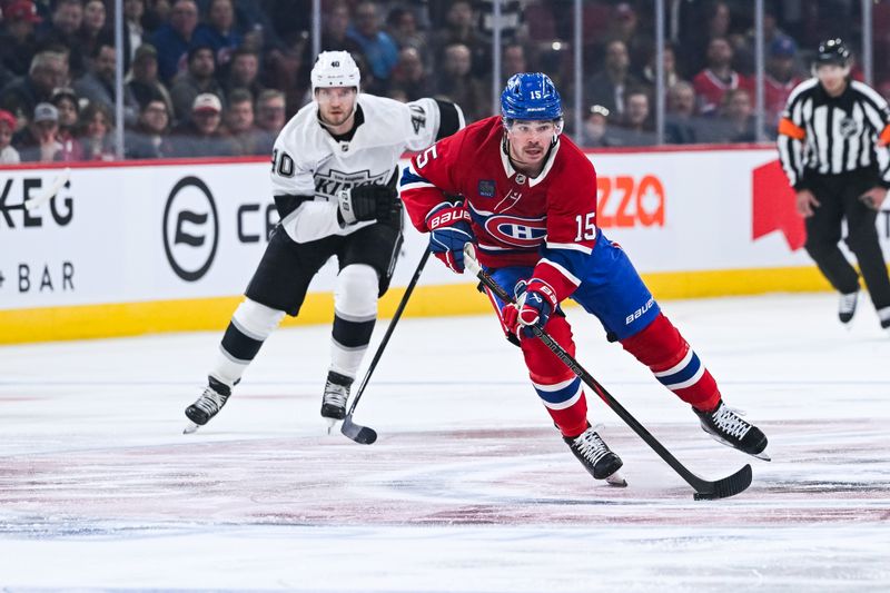 Nov 11, 2025; Montreal, Quebec, CAN; Montreal Canadiens center Alex Newhook (15) plays the puck against Los Angeles Kings right wing Joel Armia (40) during the first period at Bell Centre. Mandatory Credit: David Kirouac-Imagn Images