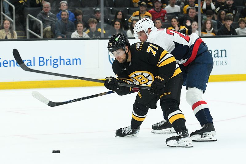 Sep 21, 2025; Boston, Massachusetts, USA; Washington Capitals forward Sheldon Rempal defends Boston Bruins left wing Viktor Arvidsson (71) during the third period at TD Garden. Mandatory Credit: Bob DeChiara-Imagn Images