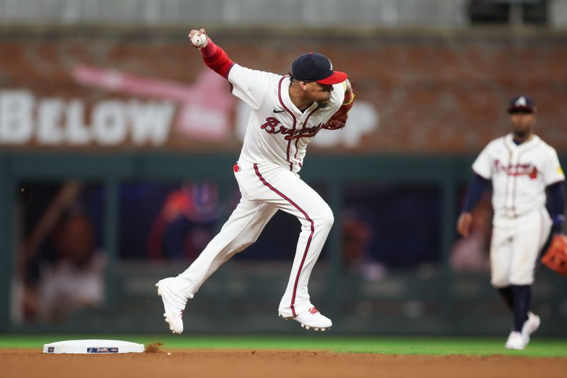 Sep 24, 2024; Atlanta, Georgia, USA; Atlanta Braves shortstop Orlando Arcia (11) throws a runner out at first against the New York Mets in the seventh inning at Truist Park. Mandatory Credit: Brett Davis-Imagn Images
