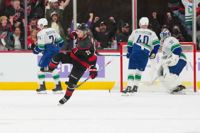 Nov 14, 2025; Raleigh, North Carolina, USA;  Carolina Hurricanes center Sebastian Aho (20) celebrates his game winning over time goal against the Vancouver Canucks at Lenovo Center. Mandatory Credit: James Guillory-Imagn Images