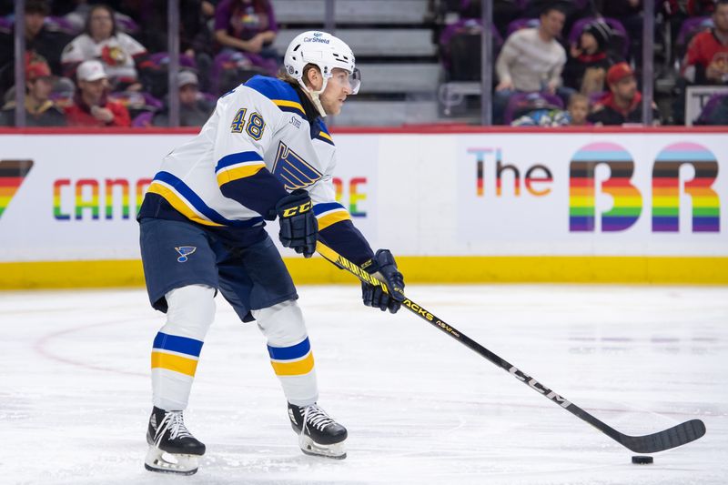 Mar 21, 2024; Ottawa, Ontario, CAN; St. Louis Blues defenseman Scott Perunovich (48) controls the puck in the first period against the Ottawa Senators at the Canadian Tire Centre. Mandatory Credit: Marc DesRosiers-USA TODAY Sports