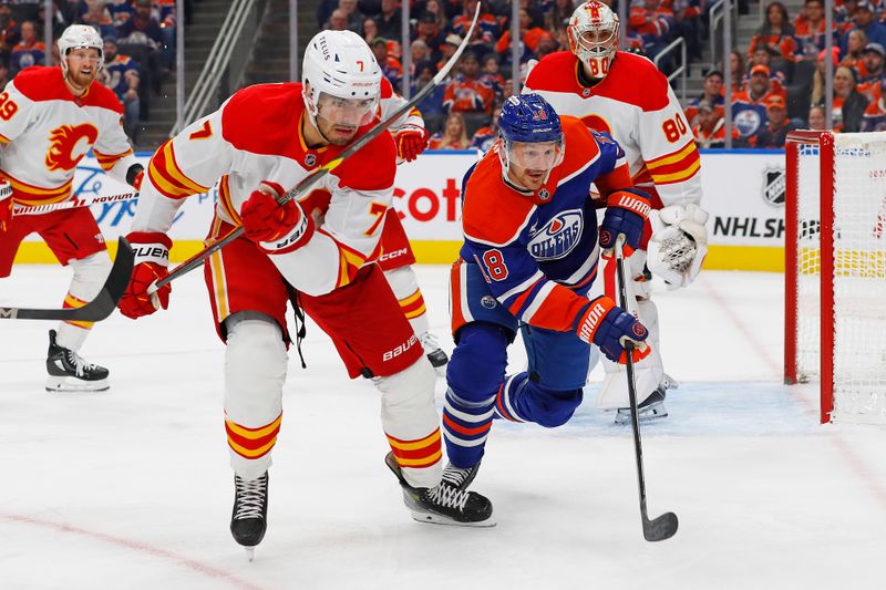 Oct 13, 2024; Edmonton, Alberta, CAN; Calgary Flames defensemen Kevin Bahl (7) and Edmonton Oilers forward Zach Hyman (18) chase a loose puck during the first period at Rogers Place. Mandatory Credit: Perry Nelson-Imagn Images