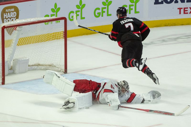 Dec 12, 2023; Ottawa, Ontario, CAN; Carolina Hurricanes goalie Pyotr Kochetkov (52) comes out of the crease to make a save on a penalty shot from Ottawa Senators left wing Brady Tkachuk (7) in the third period at the Canadian Tire Centre. Mandatory Credit: Marc DesRosiers-USA TODAY Sports.