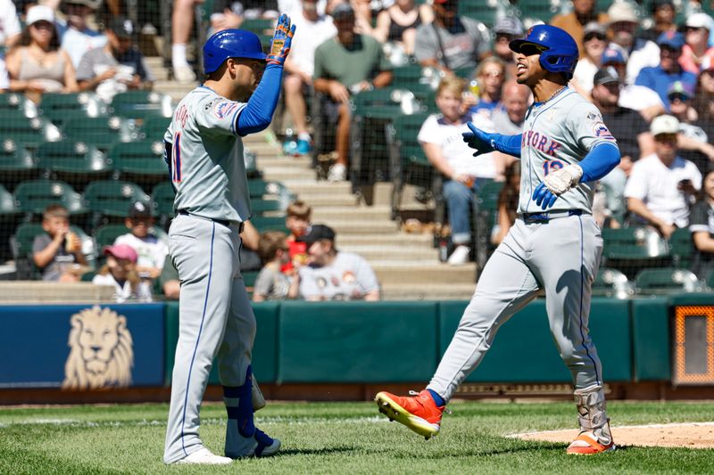Sep 1, 2024; Chicago, Illinois, USA; New York Mets shortstop Francisco Lindor (12) celebrates with second baseman Jose Iglesias (11) after hitting a solo home run against the Chicago White Sox during the fourth inning at Guaranteed Rate Field. Mandatory Credit: Kamil Krzaczynski-USA TODAY Sports