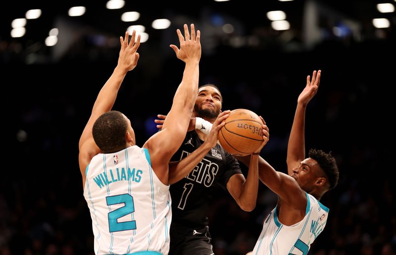 NEW YORK, NEW YORK - NOVEMBER 19:  Ziaire Williams #1 of the Brooklyn Nets shoots against Grant Williams #2 and Brandon Miller #24 of the Charlotte Hornets during their game at Barclays Center on November 19, 2024 in New York City.   User expressly acknowledges and agrees that, by downloading and or using this photograph, User is consenting to the terms and conditions of the Getty Images License Agreement.  (Photo by Al Bello/Getty Images)