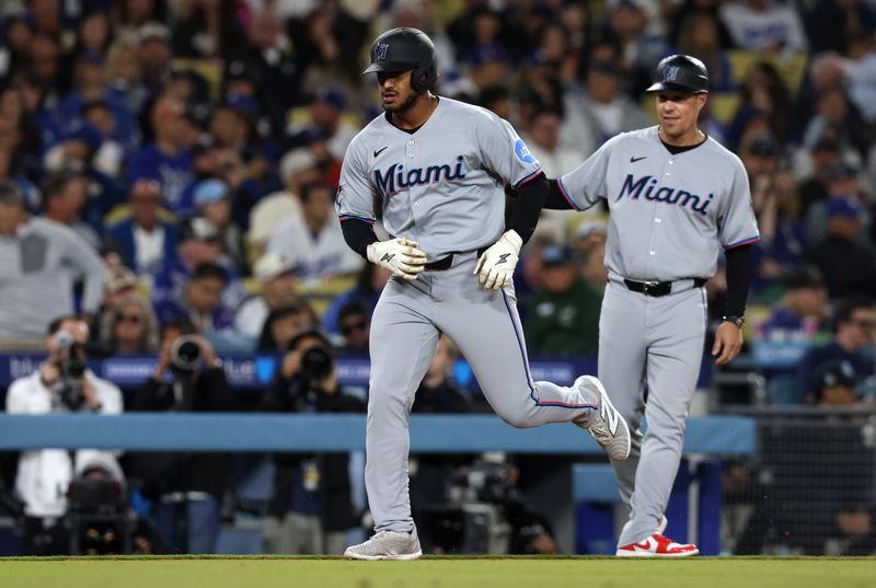 Apr 28, 2025; Los Angeles, California, USA; Miami Marlins outfielder Dane Myers (54) celebrates with third base coach Blake Lalli (45) after hitting a grand slam during the sixth inning against the Los Angeles Dodgers at Dodger Stadium. Mandatory Credit: Jason Parkhurst-Imagn Images