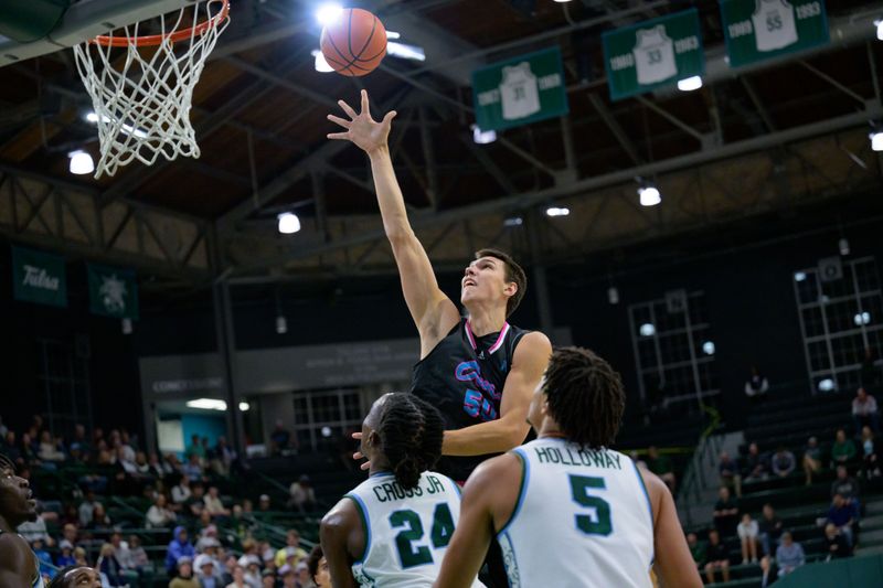 Jan 11, 2024; New Orleans, Louisiana, USA;  Florida Atlantic Owls center Vladislav Goldin (50) shoots over Tulane Green Wave forward Kevin Cross (24) during the first half at Avron B. Fogelman Arena in Devlin Fieldhouse. Mandatory Credit: Matthew Hinton-USA TODAY Sports