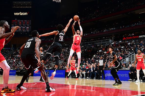 ATLANTA, GA - DECEMBER 6: Dejounte Murray #5 of the Atlanta Hawks shoots the ball during the game against the Brooklyn Nets on December 6, 2023 at State Farm Arena in Atlanta, Georgia.  NOTE TO USER: User expressly acknowledges and agrees that, by downloading and/or using this Photograph, user is consenting to the terms and conditions of the Getty Images License Agreement. Mandatory Copyright Notice: Copyright 2023 NBAE (Photo by Scott Cunningham/NBAE via Getty Images)