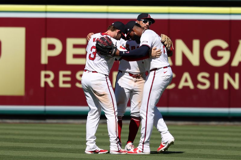 Jul 28, 2024; Anaheim, California, USA;  Los Angeles Angels left fielder Taylor Ward (3) and center fielder Kevin Pillar (12) and right fielder Jo Adell (7) celebrate a victory after defeating the Oakland Athletics 8-6 at Angel Stadium. Mandatory Credit: Kiyoshi Mio-USA TODAY Sports