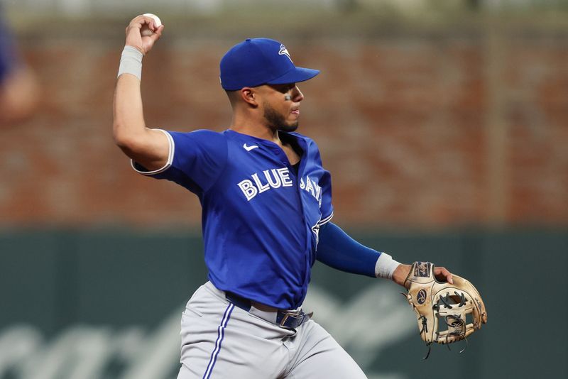 Sep 6, 2024; Atlanta, Georgia, USA; Toronto Blue Jays shortstop Leo Jimenez (49) throws a runner out at first against the Atlanta Braves in the fifth inning at Truist Park. Mandatory Credit: Brett Davis-Imagn Images