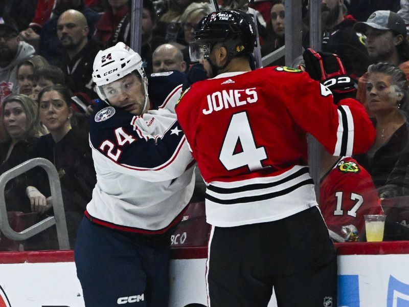 Mar 2, 2024; Chicago, Illinois, USA;  Columbus Blue Jackets right wing Mathieu Olivier (24) gets hit by Chicago Blackhawks defenseman Seth Jones (4) during the first period at the  United Center. Mandatory Credit: Matt Marton-USA TODAY Sports