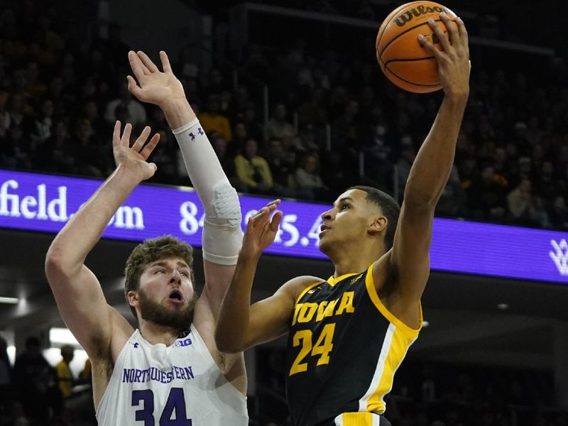 Feb 19, 2023; Evanston, Illinois, USA; Northwestern Wildcats center Matthew Nicholson (34) defends Iowa Hawkeyes forward Kris Murray (24) during the first half at Welsh-Ryan Arena. Mandatory Credit: David Banks-USA TODAY Sports