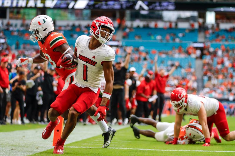 Nov 18, 2023; Miami Gardens, Florida, USA; Louisville Cardinals wide receiver Jamari Thrash (1) runs with the football for a touchdown against the Miami Hurricanes during the fourth quarter at Hard Rock Stadium. Mandatory Credit: Sam Navarro-USA TODAY Sports