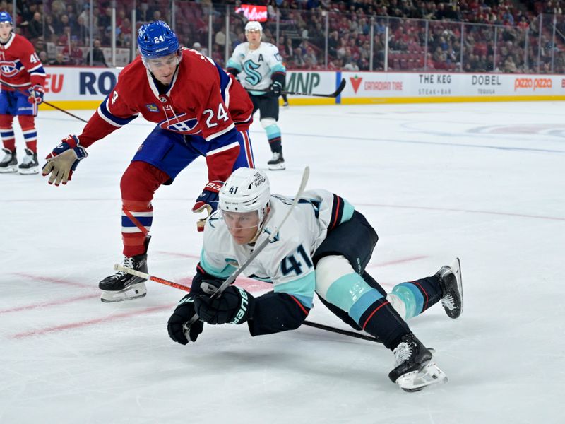 Oct 29, 2024; Montreal, Quebec, CAN; Montreal Canadiens defenseman Logan Mailloux (24) trips Seattle Kraken defenseman Ryker Evans (41) during the third period at the Bell Centre. Mandatory Credit: Eric Bolte-Imagn Images