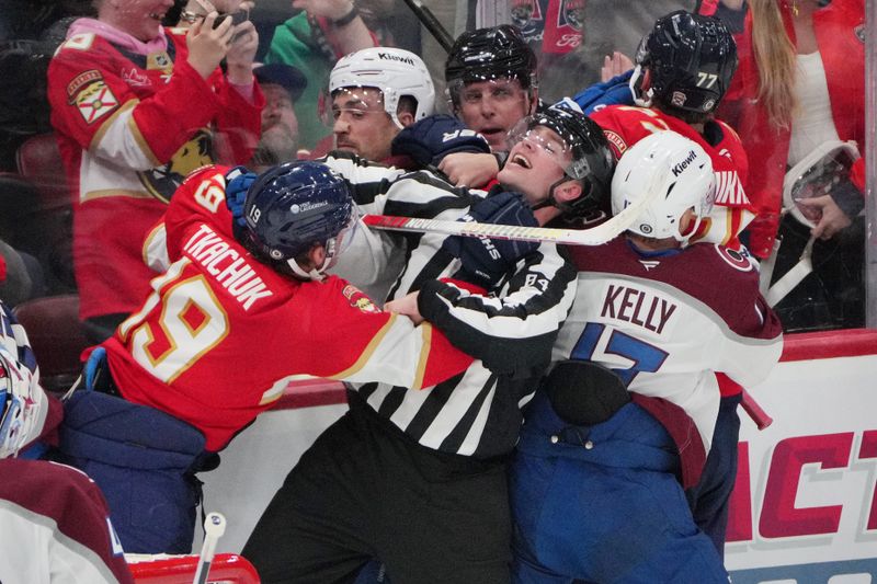 Nov 23, 2024; Sunrise, Florida, USA; Linesperson Ryan Jackson (84) gets in the middle of a scrum between Florida Panthers left wing Matthew Tkachuk (19) and Colorado Avalanche in the third period at Amerant Bank Arena. Mandatory Credit: Jim Rassol-Imagn Images