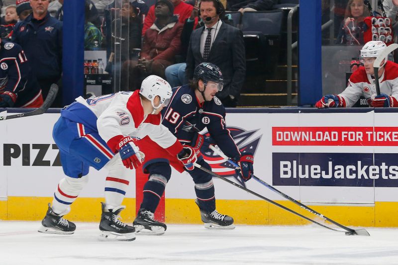 Nov 27, 2024; Columbus, Ohio, USA; Columbus Blue Jackets center Adam Fantilli (19) and Montreal Canadiens right wing Joel Armia (40) battle for the puck during the first period at Nationwide Arena. Mandatory Credit: Russell LaBounty-Imagn Images