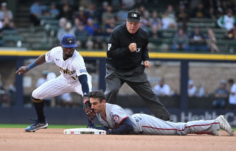 Sep 17, 2023; Milwaukee, Wisconsin, USA; Washington Nationals catcher Drew Millas (81) slides in safely ahead of the tag by Milwaukee Brewers second baseman Andruw Monasterio (14) in the eighth inning at American Family Field. Mandatory Credit: Michael McLoone-USA TODAY Sports