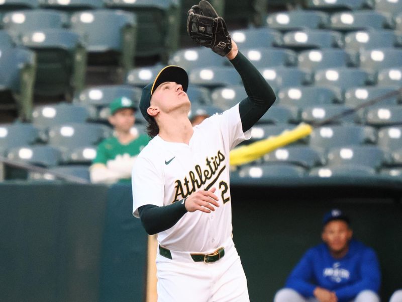 Jun 19, 2024; Oakland, California, USA; Oakland Athletics second baseman Zack Gelof (20) catches the ball against the Kansas City Royals during the third inning at Oakland-Alameda County Coliseum. Mandatory Credit: Kelley L Cox-USA TODAY Sports