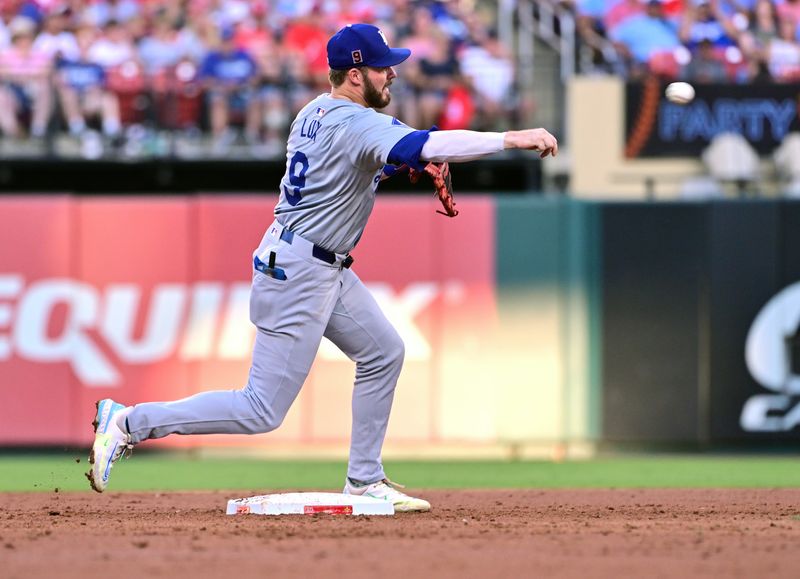 Aug 17, 2024; St. Louis, Missouri, USA; Los Angeles Dodgers second base Gavin Lux (9) throws to first base for a double play on St. Louis Cardinals players Lars Nootbaar and Paul Goldschmidt (not shown) in the second inning at Busch Stadium. Mandatory Credit: Tim Vizer-USA TODAY Sports