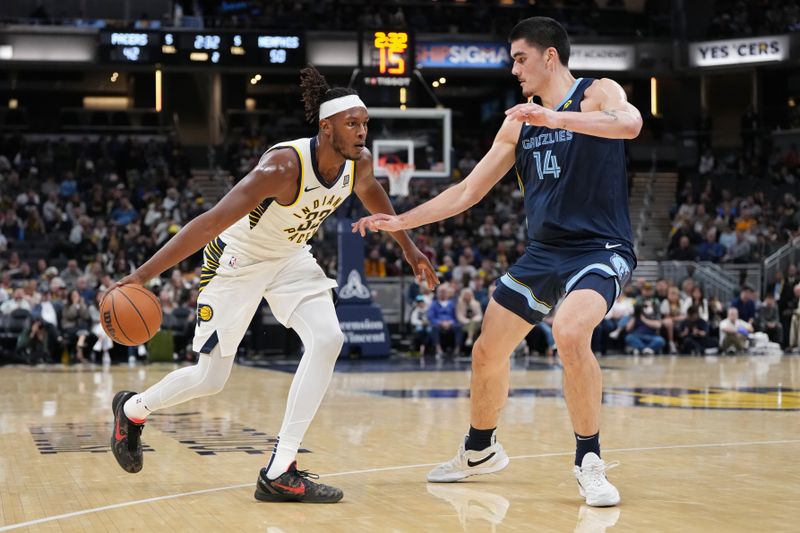 INDIANAPOLIS, INDIANA - OCTOBER 14:  Myles Turner #33 of the Indiana Pacers dribbles the ball against Zach Edey #14 of the Memphis Grizzlies in the second quarter of a preseason game at Gainbridge Fieldhouse on October 14, 2024 in Indianapolis, Indiana. NOTE TO USER: User expressly acknowledges and agrees that, by downloading and or using this photograph, User is consenting to the terms and conditions of the Getty Images License Agreement. (Photo by Dylan Buell/Getty Images)