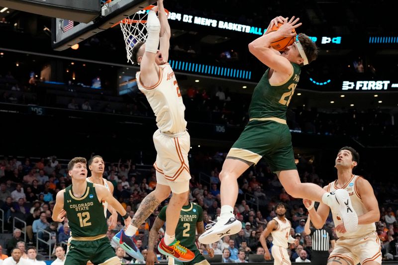 Mar 21, 2024; Charlotte, NC, USA; Colorado State Rams guard Joe Palmer (20) secures the ball against Texas Longhorns guard Chendall Weaver (2) in the first round of the 2024 NCAA Tournament at Spectrum Center. Mandatory Credit: Jim Dedmon-USA TODAY Sports