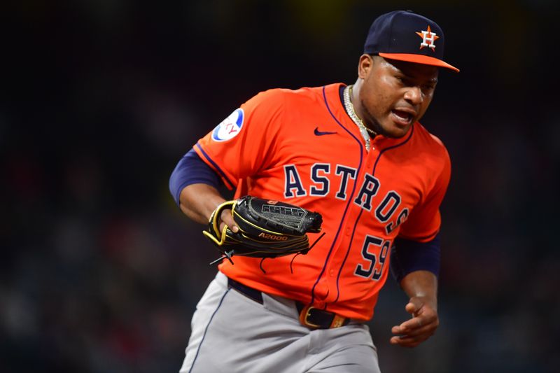 Jun 7, 2024; Anaheim, California, USA; Houston Astros pitcher Framber Valdez (59) tags first for the out against Los Angeles Angels first base Nolan Schanuel (18) during the ninth inning at Angel Stadium. Mandatory Credit: Gary A. Vasquez-USA TODAY Sports