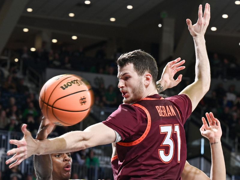 Feb 10, 2024; South Bend, Indiana, USA; Notre Dame Fighting Irish guard Markus Burton (3) passes the ball around Virginia Tech Hokies forward Robbie Beran (31) in the second half at the Purcell Pavilion. Mandatory Credit: Matt Cashore-USA TODAY Sports