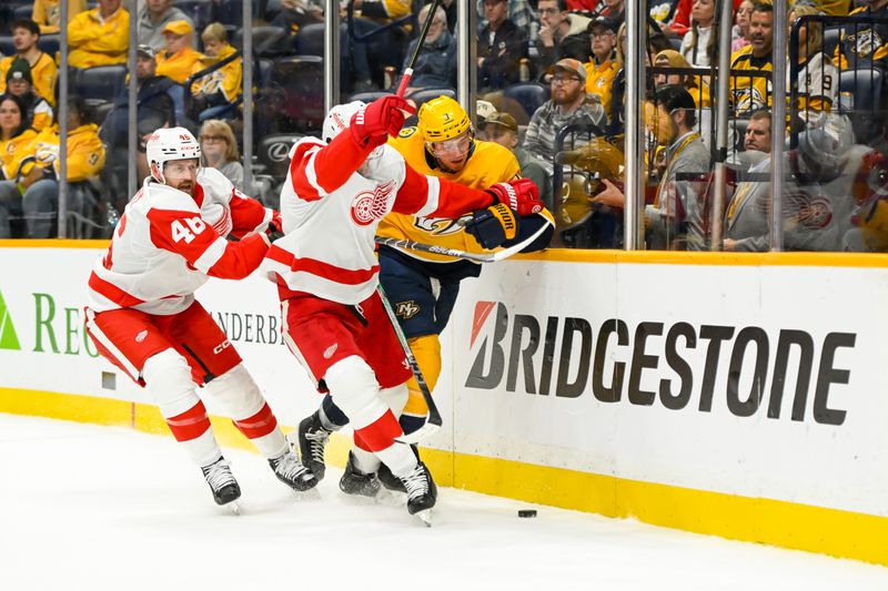 Oct 19, 2024; Nashville, Tennessee, USA; Detroit Red Wings defenseman Ben Chiarot (8) and Nashville Predators defenseman Jeremy Lauzon (3) battle for the puck during the first period at Bridgestone Arena. Mandatory Credit: Steve Roberts-Imagn Images