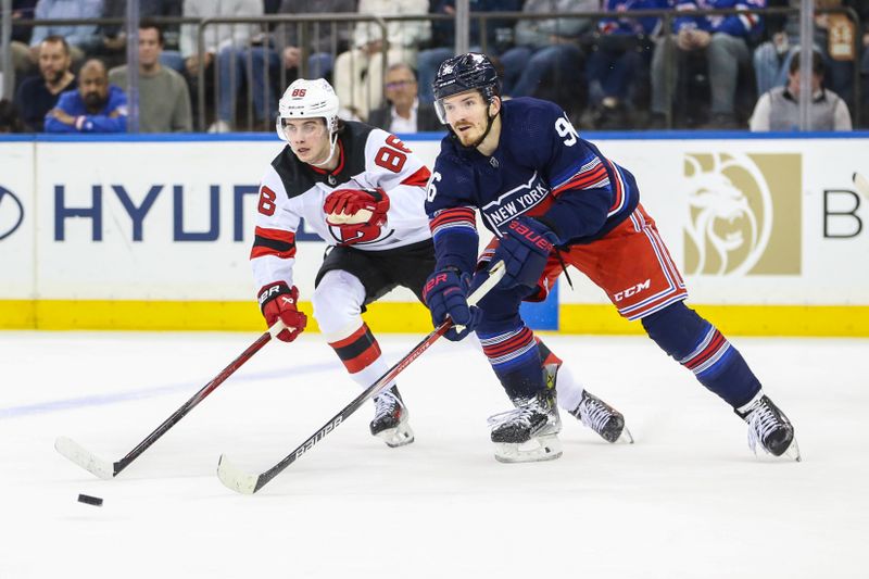 Apr 3, 2024; New York, New York, USA; New York Rangers center Jack Roslovic (96) and New Jersey Devils center Jack Hughes (86) chase the puck in the second period at Madison Square Garden. Mandatory Credit: Wendell Cruz-USA TODAY Sports