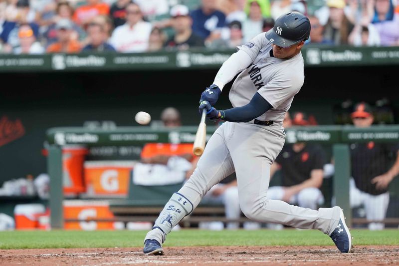 Jul 13, 2024; Baltimore, Maryland, USA; New York Yankees outfielder Juan Soto (22) connects for a solo home run in the fifth inning against the Baltimore Orioles at Oriole Park at Camden Yards. Mandatory Credit: Mitch Stringer-USA TODAY Sports