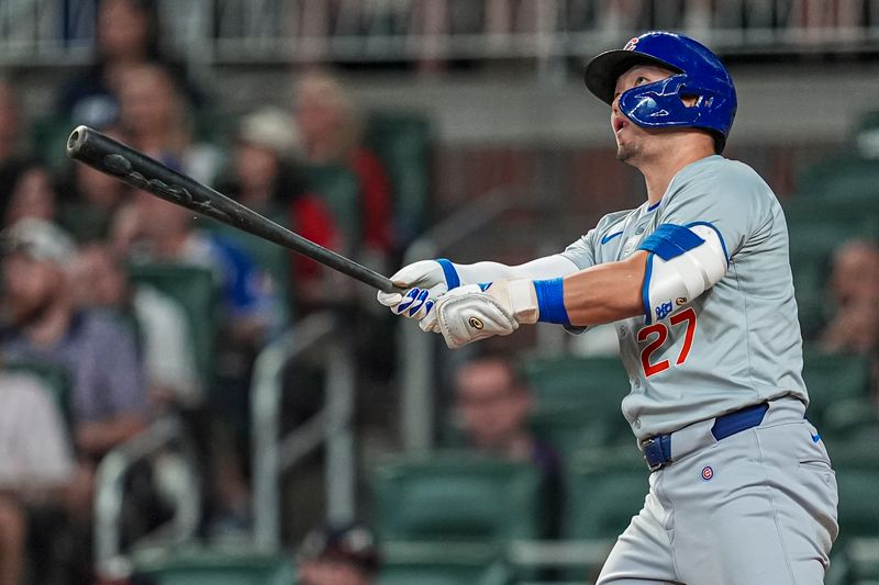 May 15, 2024; Cumberland, Georgia, USA; Chicago Cubs right fielder Seiya Suzuki (27)  hits a home run against the Atlanta Braves during the eighth inning at Truist Park. Mandatory Credit: Dale Zanine-USA TODAY Sports