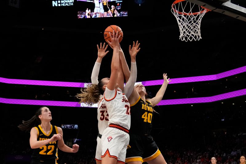 Nov 9, 2023; Charlotte, North Carolina, USA; Virginia Tech Hokies guard Cayla King (22) goes up for a shot against Iowa Hawkeyes center Sharon Goodman (40) during the first half at Spectrum Center. Mandatory Credit: Jim Dedmon-USA TODAY Sports