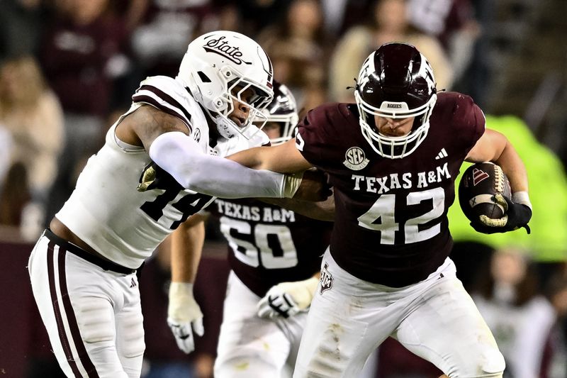 Nov 11, 2023; College Station, Texas, USA; Texas A&M Aggies tight end Max Wright (42) runs the ball as Mississippi State Bulldogs linebacker Nathaniel Watson (14) defends during the second half at Kyle Field. Mandatory Credit: Maria Lysaker-USA TODAY Sports