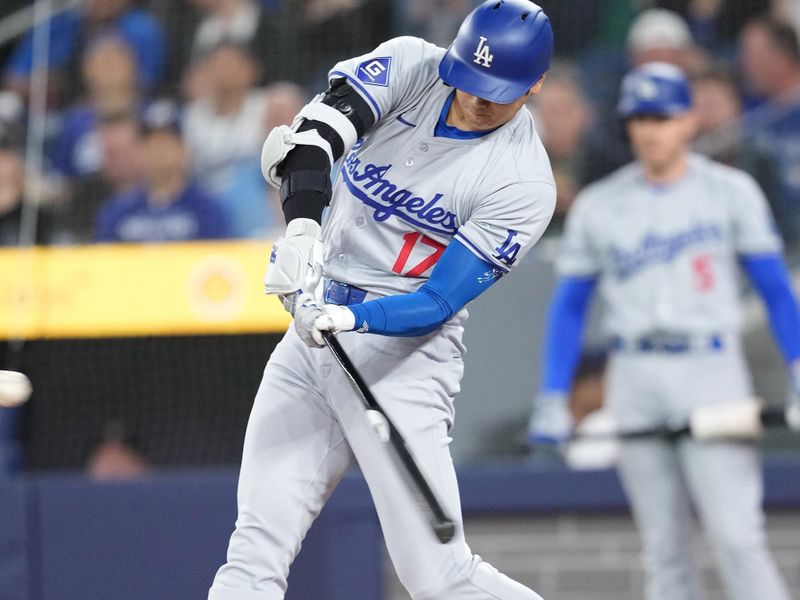 Apr 26, 2024; Toronto, Ontario, CAN; Los Angeles Dodgers designated hitter Shohei Ohtani (17) hits a home run against the Toronto Blue Jays during the first inning at Rogers Centre. Mandatory Credit: Nick Turchiaro-USA TODAY Sports