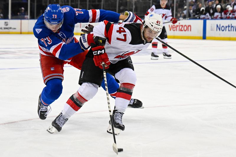 Oct 2, 2025; New York, New York, USA;  New York Rangers center Matt Rempe (73) defends against New Jersey Devils left wing Paul Cotter (47) during the third period at Madison Square Garden. Mandatory Credit: Dennis Schneidler-Imagn Images