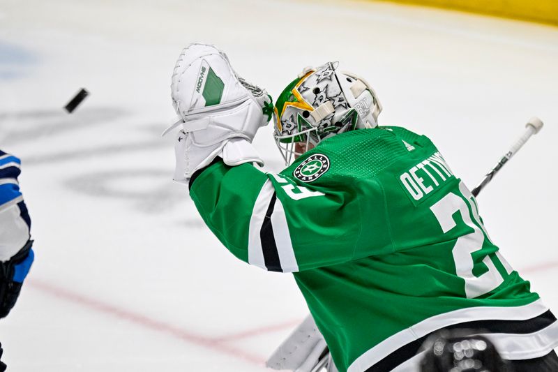 Apr 11, 2024; Dallas, Texas, USA; Dallas Stars goaltender Jake Oettinger (29) makes a glove save on a Winnipeg Jets shot during the first period at the American Airlines Center. Mandatory Credit: Jerome Miron-USA TODAY Sports