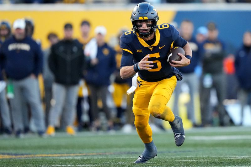 Nov 18, 2023; Morgantown, West Virginia, USA; West Virginia Mountaineers quarterback Garrett Greene (6) carries the ball on a touchdown run against the Cincinnati Bearcats in the third quarter at Milan Puskar Stadium. West Virginia won 42-21. Mandatory Credit: Kareem Elgazzar-USA TODAY Sports